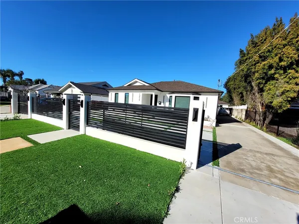 a view of a house with a yard next to a road