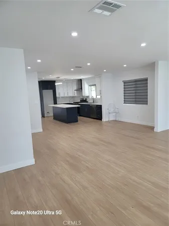 a view of kitchen and refrigerator