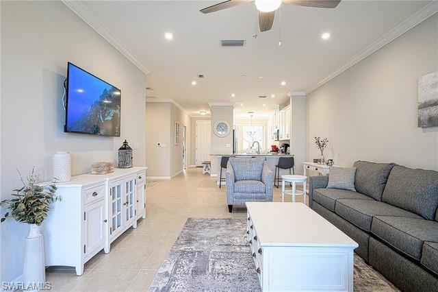 9365 Pocida Court, Unit 102 Naples, FL 34119 - Photo 12 of 38 a living room with furniture kitchen view and a large window