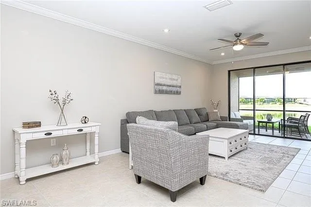 a living room with furniture and large windows