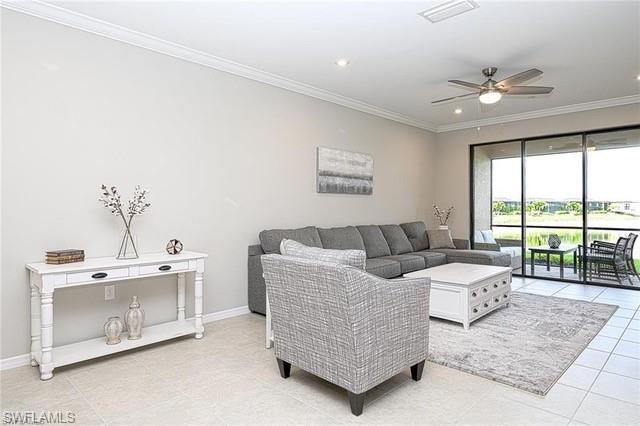 9365 Pocida Court, Unit 102 Naples, FL 34119 - Photo 13 of 38 a living room with furniture and large windows