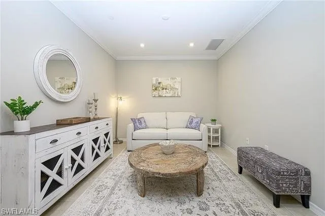 a living room with furniture and a dresser