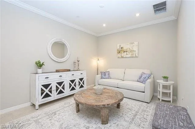 a living room with furniture a window and wall