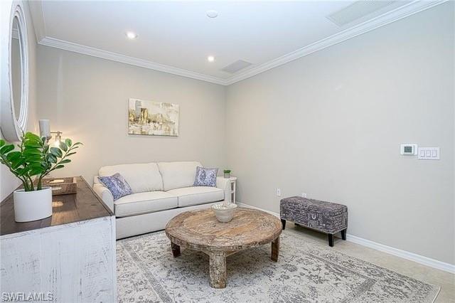 9365 Pocida Court, Unit 102 Naples, FL 34119 - Photo 16 of 38 a living room with furniture a rug and a potted plant
