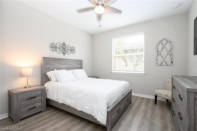 9365 Pocida Court, Unit 102 Naples, FL 34119 - Photo 17 of 38 a bedroom with a bed and a window