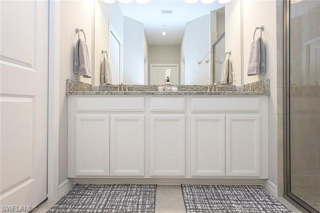 9365 Pocida Court, Unit 102 Naples, FL 34119 - Photo 18 of 38 a bathroom with a sink and a mirror