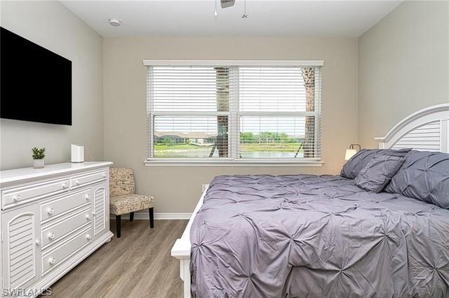 9365 Pocida Court, Unit 102 Naples, FL 34119 - Photo 21 of 38 a bedroom with a bed and a flat screen tv