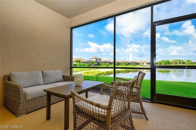 9365 Pocida Court, Unit 102 Naples, FL 34119 - Photo 25 of 38 a view of a patio with a table chairs and a swimming pool