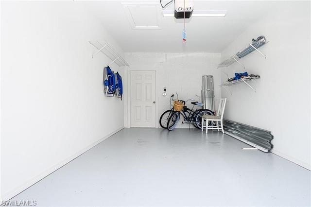 9365 Pocida Court, Unit 102 Naples, FL 34119 - Photo 27 of 38 a view of a livingroom with furniture and a ceiling fan