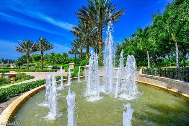 9365 Pocida Court, Unit 102 Naples, FL 34119 - Photo 30 of 38 a garden view with boat