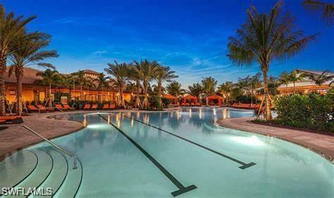 9365 Pocida Court, Unit 102 Naples, FL 34119 - Photo 31 of 38 a view of swimming pool with outdoor seating