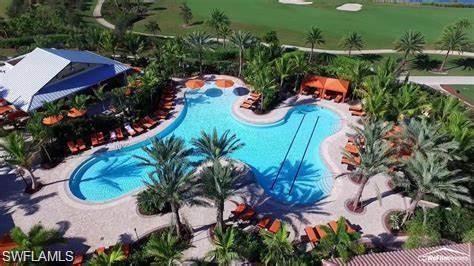 9365 Pocida Court, Unit 102 Naples, FL 34119 - Photo 32 of 38 an aerial view of swimming pool and outdoor space