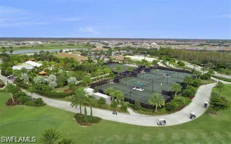 9365 Pocida Court, Unit 102 Naples, FL 34119 - Photo 35 of 38 an aerial view of residential houses with outdoor space and trees