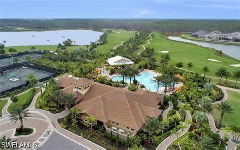 9365 Pocida Court, Unit 102 Naples, FL 34119 - Photo 36 of 38 an aerial view of residential houses with outdoor space and trees