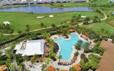 9365 Pocida Court, Unit 102 Naples, FL 34119 - Photo 37 of 38 an aerial view of a house with a garden and lake view
