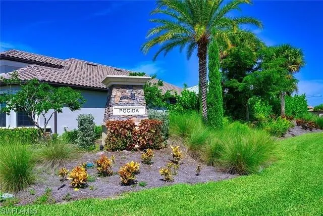 a view of a house with a yard and potted plants