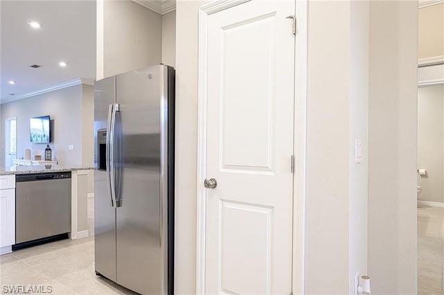 9365 Pocida Court, Unit 102 Naples, FL 34119 - Photo 8 of 38 a kitchen with a refrigerator and a sink
