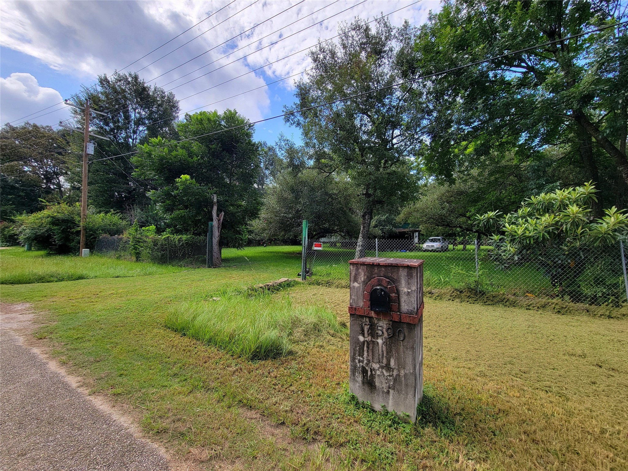 17590 Deer Run Road Conroe, TX 77306 - Photo 3 of 10 a view of a bench in the garden near a lake