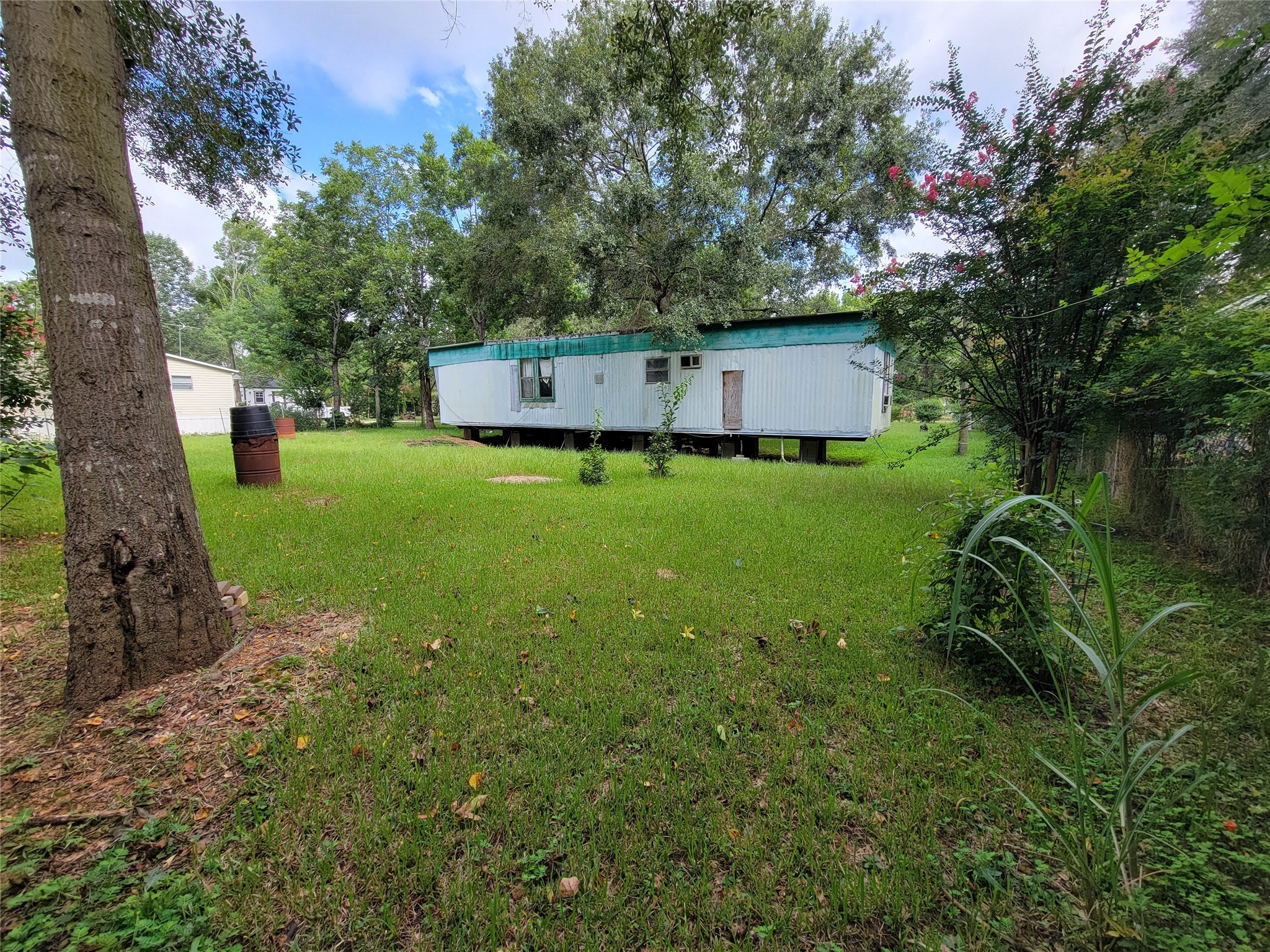 17590 Deer Run Road Conroe, TX 77306 - Photo 7 of 10 a backyard of a house with lots of green space