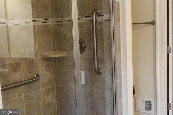 a bathroom with a glass shower door