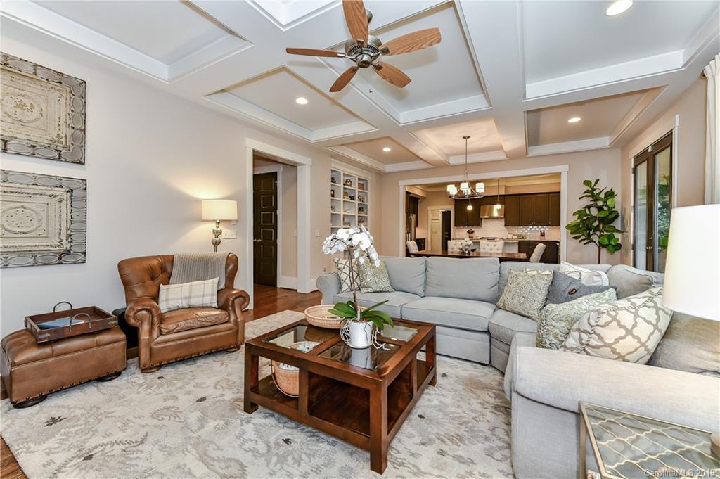 4935 Sharon View Road Charlotte, NC 28226 - Photo 13 of 48 a living room with furniture a rug and a chandelier
