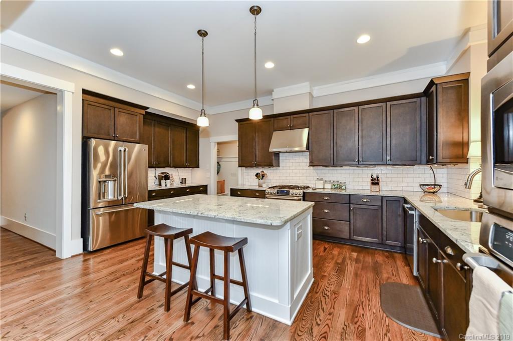 4935 Sharon View Road Charlotte, NC 28226 - Photo 18 of 48 a kitchen with stainless steel appliances granite countertop a sink stove and refrigerator