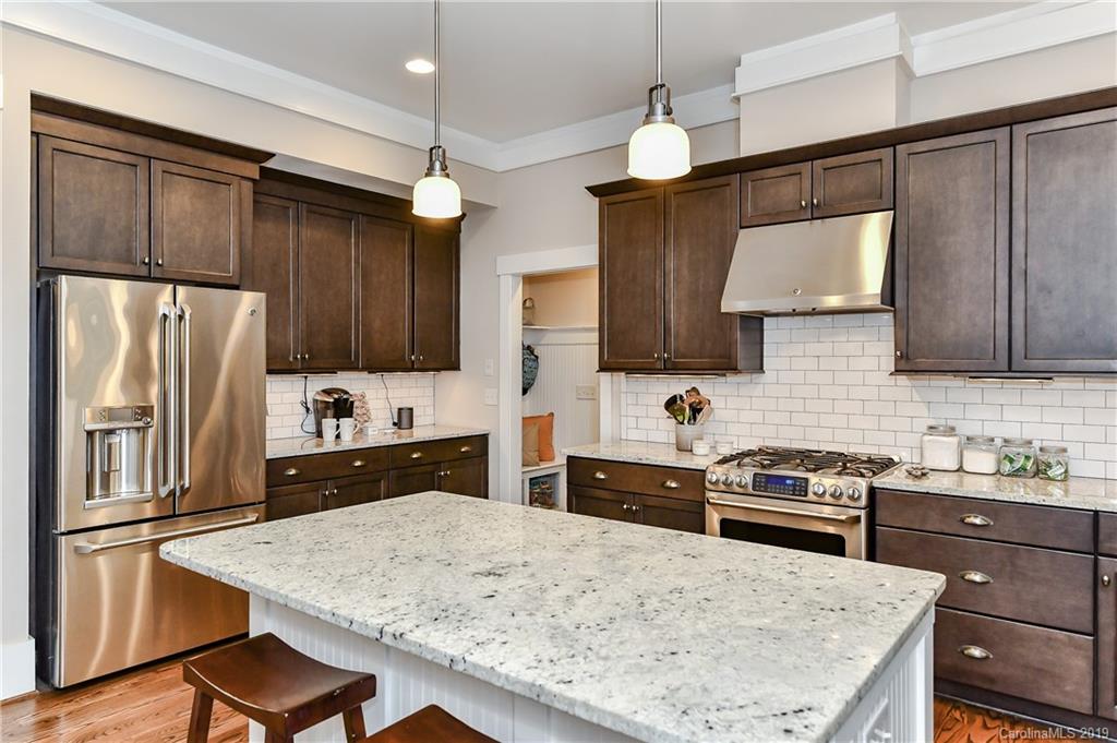 4935 Sharon View Road Charlotte, NC 28226 - Photo 19 of 48 a kitchen with stainless steel appliances a stove refrigerator sink and microwave