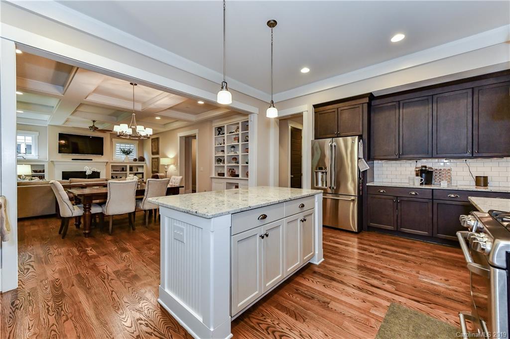 4935 Sharon View Road Charlotte, NC 28226 - Photo 20 of 48 a kitchen with granite countertop a center island stainless steel appliances cabinets and a counter top space