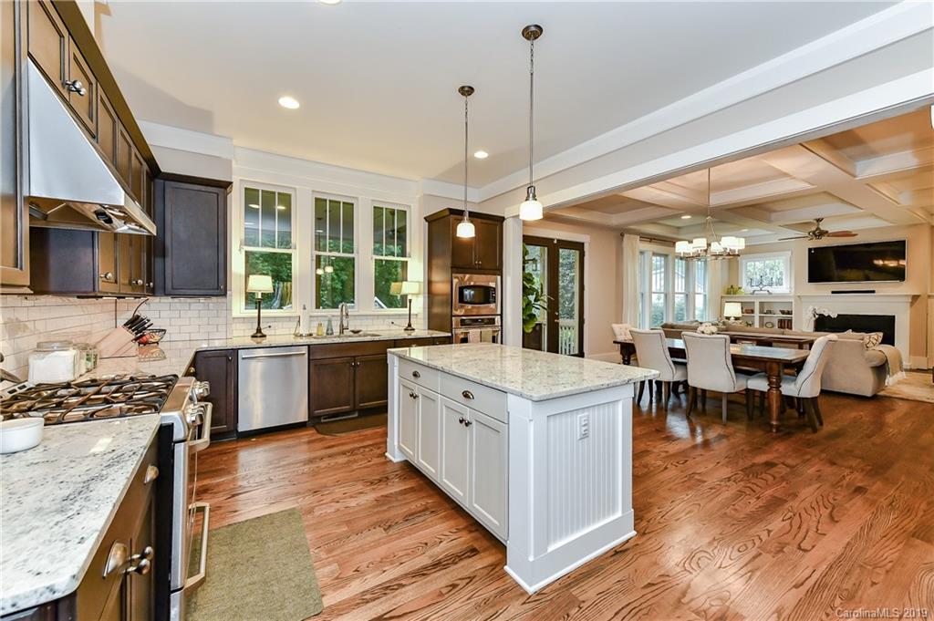4935 Sharon View Road Charlotte, NC 28226 - Photo 21 of 48 a kitchen with a sink stove cabinets and wooden floor