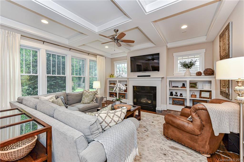 4935 Sharon View Road Charlotte, NC 28226 - Photo 24 of 48 a living room with furniture a fireplace and a flat screen tv
