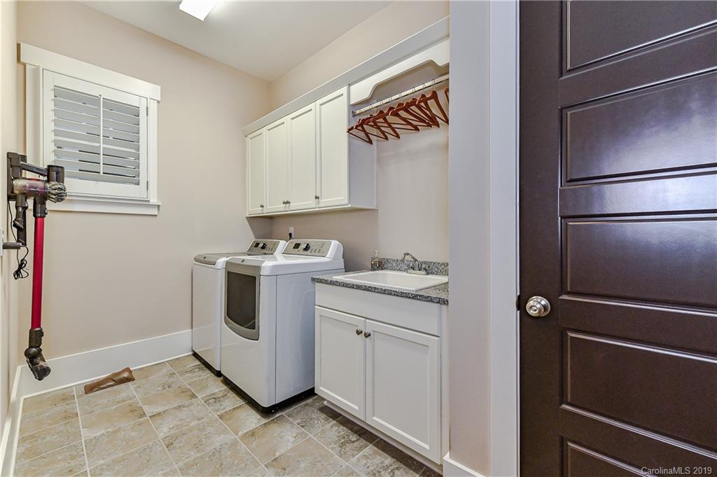 4935 Sharon View Road Charlotte, NC 28226 - Photo 28 of 48 a utility room with cabinets washer and dryer