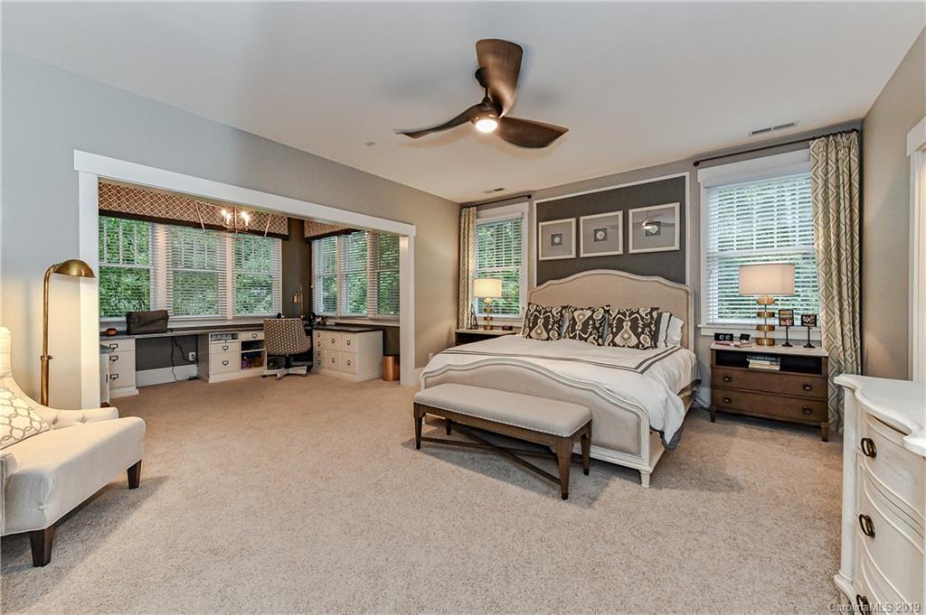 4935 Sharon View Road Charlotte, NC 28226 - Photo 30 of 48 a spacious bedroom with a bed couch and a large window