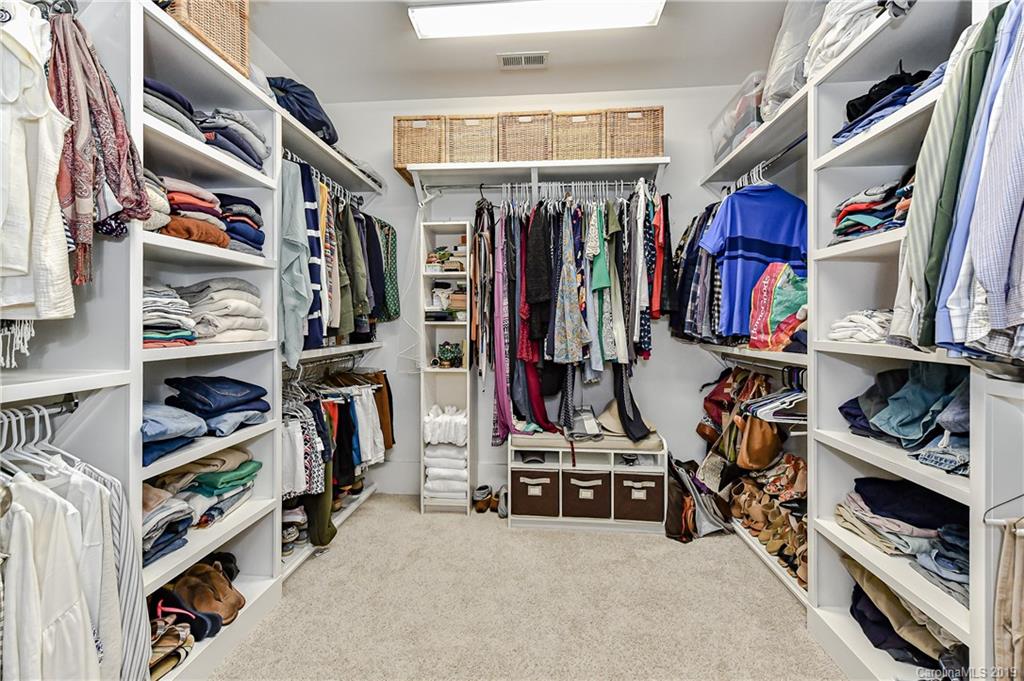 4935 Sharon View Road Charlotte, NC 28226 - Photo 35 of 48 a view of walk in closet with clothes and shoes
