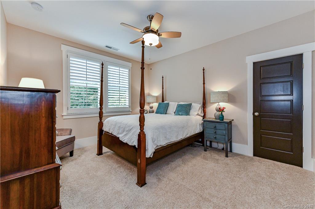 4935 Sharon View Road Charlotte, NC 28226 - Photo 36 of 48 a bedroom with a bed and a chandelier