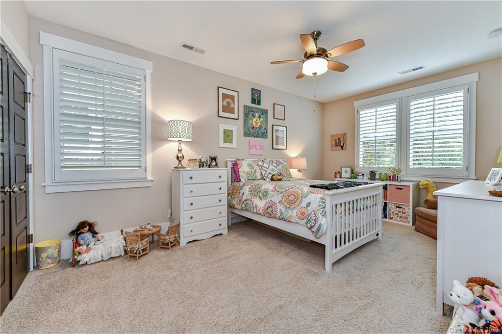 4935 Sharon View Road Charlotte, NC 28226 - Photo 39 of 48 a bedroom with a bed and a ceiling fan