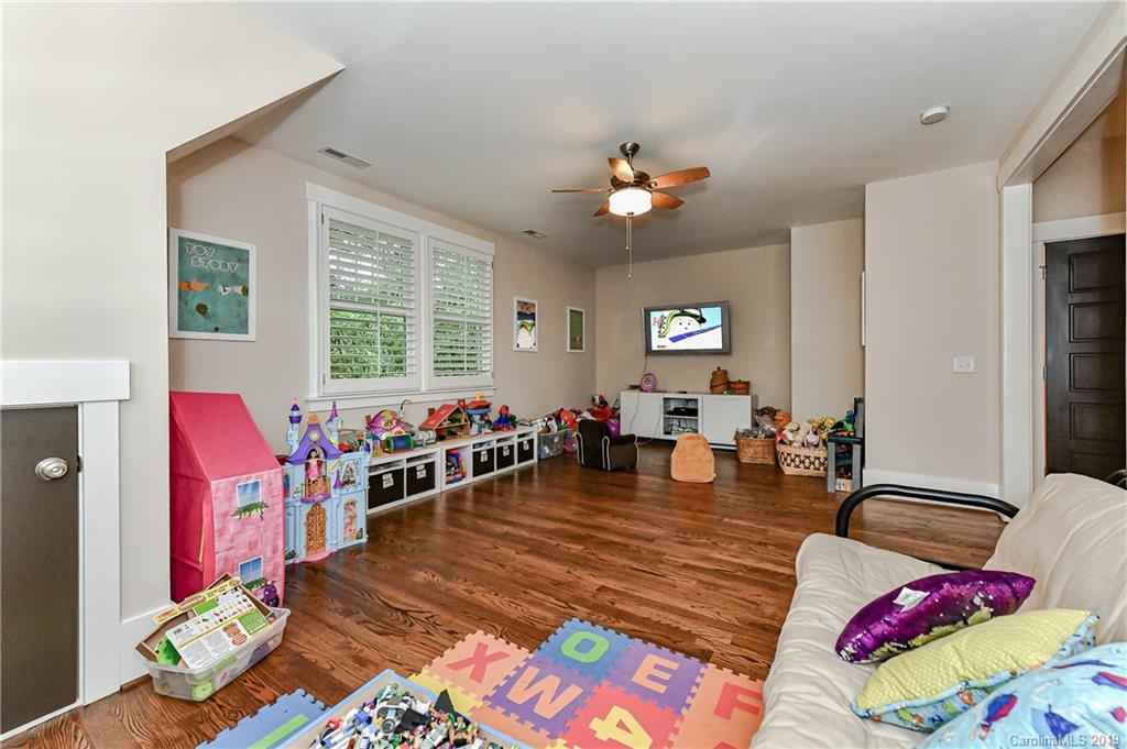 4935 Sharon View Road Charlotte, NC 28226 - Photo 42 of 48 a living room filled with furniture and a chandelier