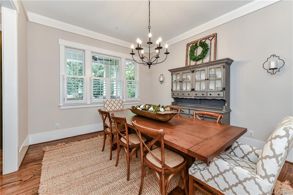 4935 Sharon View Road Charlotte, NC 28226 - Photo 9 of 48 a dining room with furniture a chandelier and wooden floor