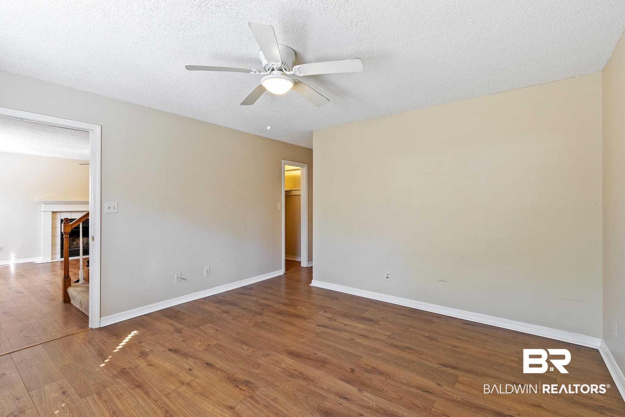 359 Ridgewood Drive Daphne, AL 36526 - Photo 31 of 73 Downstairs Primary Bedroom with LVP flooring and ceiling fan