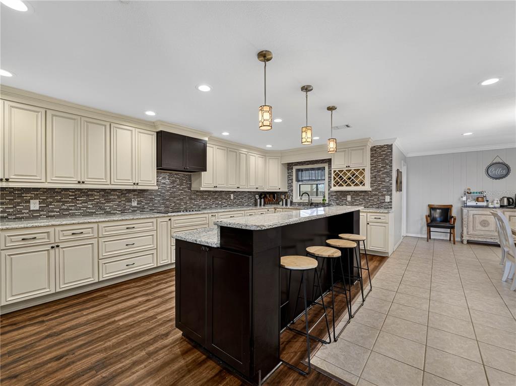4615 Kings Point Court Lakeland, FL 33813 - Photo 11 of 41 a large kitchen with stainless steel appliances granite countertop a stove a sink and a refrigerator