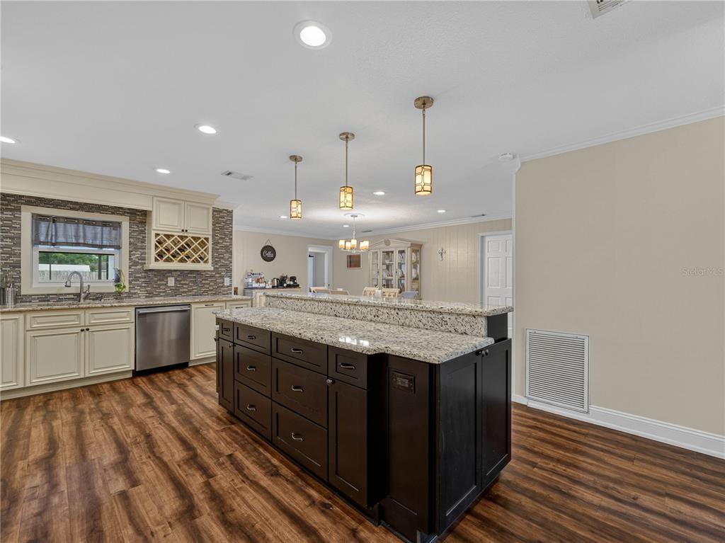 4615 Kings Point Court Lakeland, FL 33813 - Photo 12 of 41 a kitchen with a stove a sink and a refrigerator