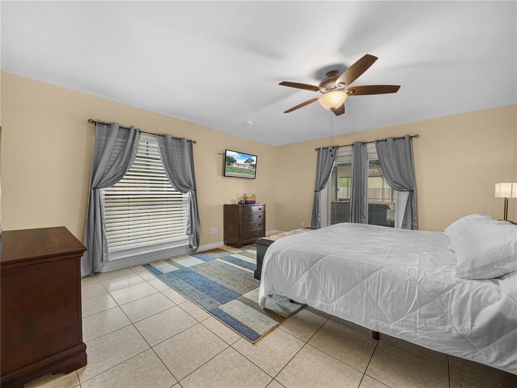 4615 Kings Point Court Lakeland, FL 33813 - Photo 16 of 41 a bedroom with a bed and a lamp on dresser