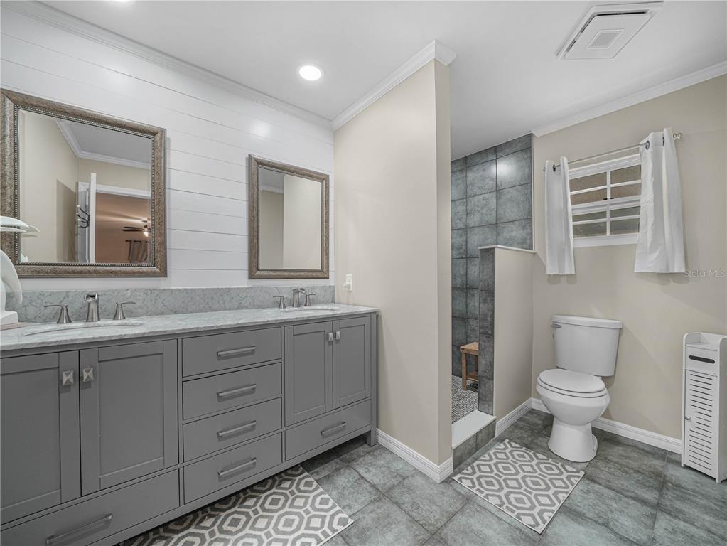 4615 Kings Point Court Lakeland, FL 33813 - Photo 17 of 41 a bathroom with a sink toilet and shower