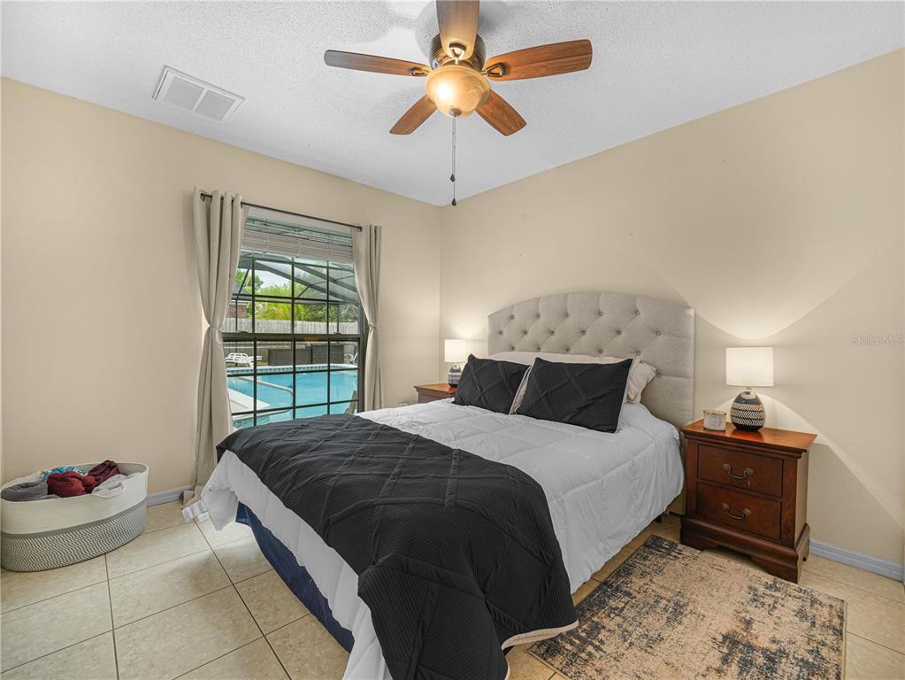 4615 Kings Point Court Lakeland, FL 33813 - Photo 19 of 41 a bedroom with a bed and a chandelier