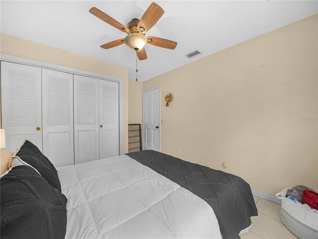 4615 Kings Point Court Lakeland, FL 33813 - Photo 20 of 41 a bedroom with a bed and a chandelier