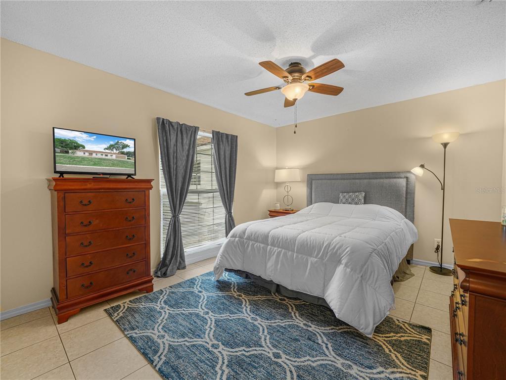 4615 Kings Point Court Lakeland, FL 33813 - Photo 21 of 41 a bedroom with a bed and a dresser