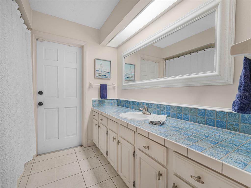 4615 Kings Point Court Lakeland, FL 33813 - Photo 23 of 41 a hallway with a sink and cabinets