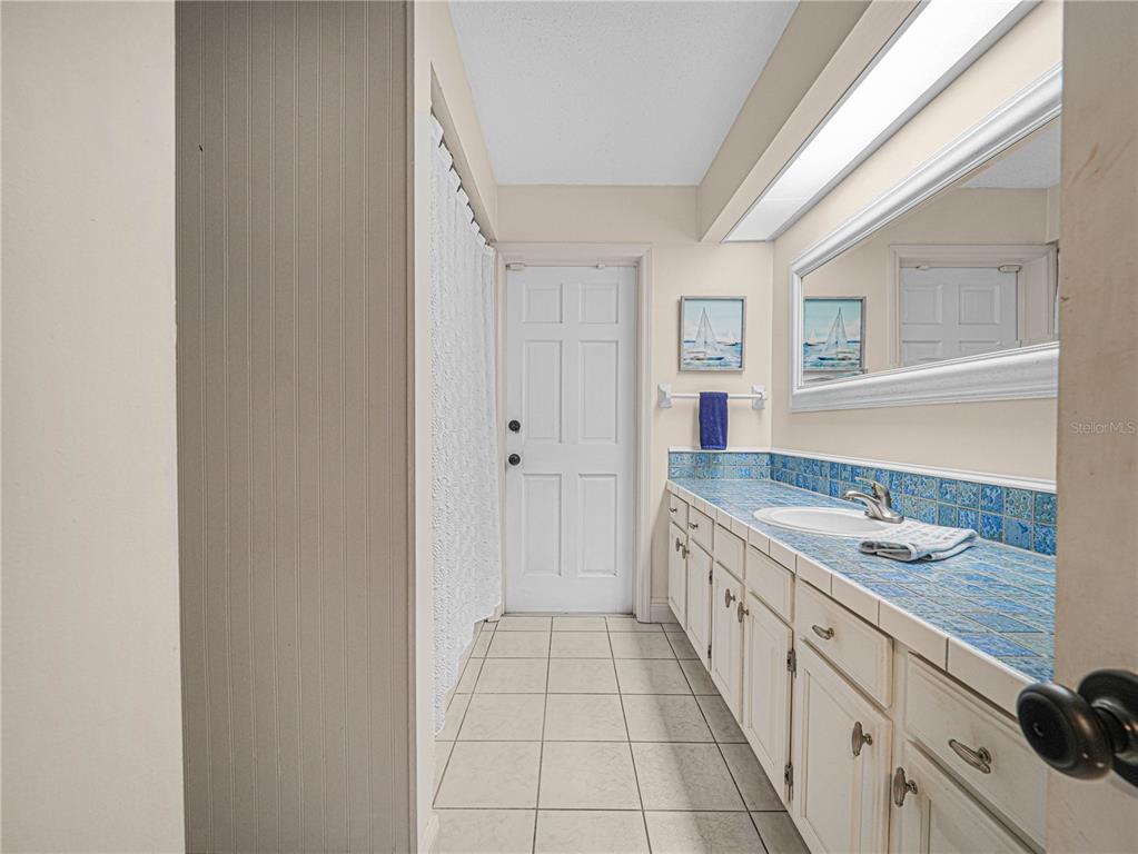 4615 Kings Point Court Lakeland, FL 33813 - Photo 24 of 41 a bathroom with a granite countertop sink and a mirror