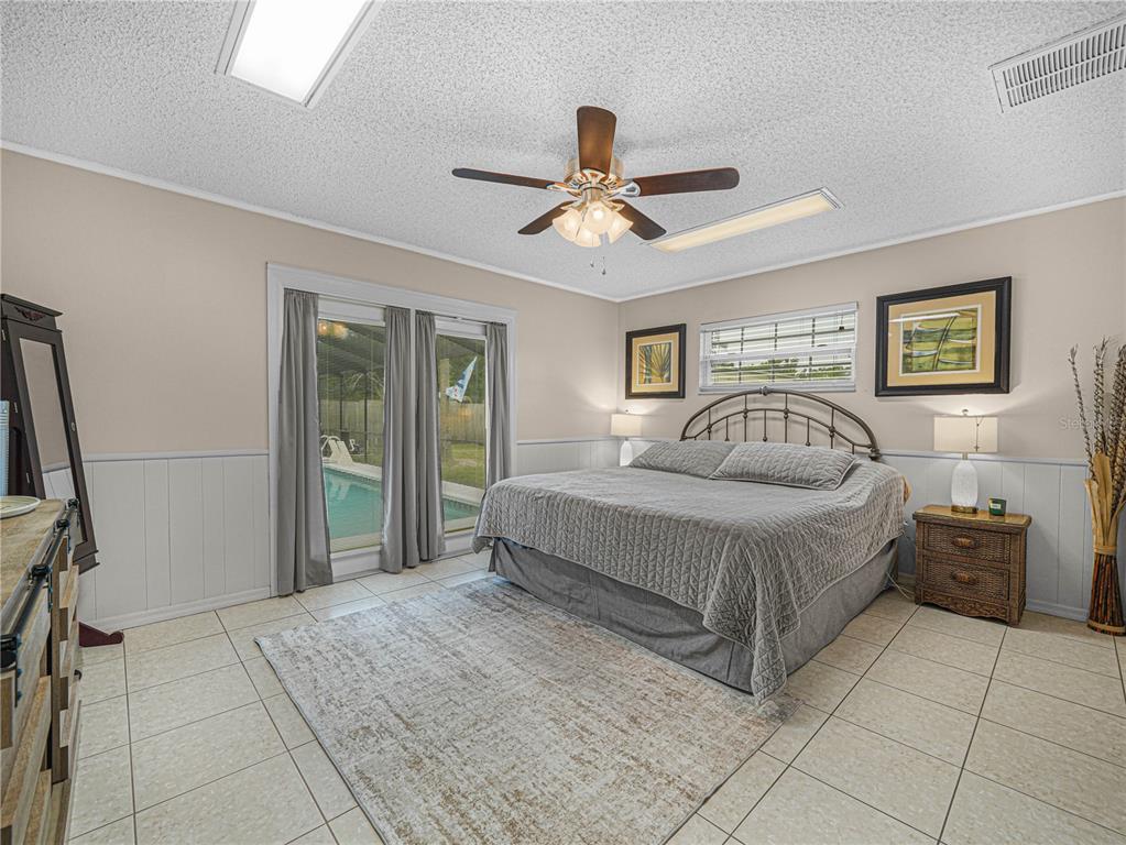 4615 Kings Point Court Lakeland, FL 33813 - Photo 27 of 41 a bedroom with a bed and a chandelier