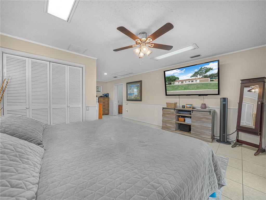 4615 Kings Point Court Lakeland, FL 33813 - Photo 28 of 41 a view of a livingroom with furniture and a flat screen tv