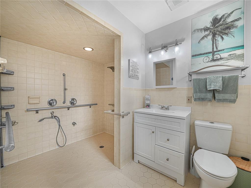 4615 Kings Point Court Lakeland, FL 33813 - Photo 30 of 41 a bathroom with a toilet sink vanity granite and shower